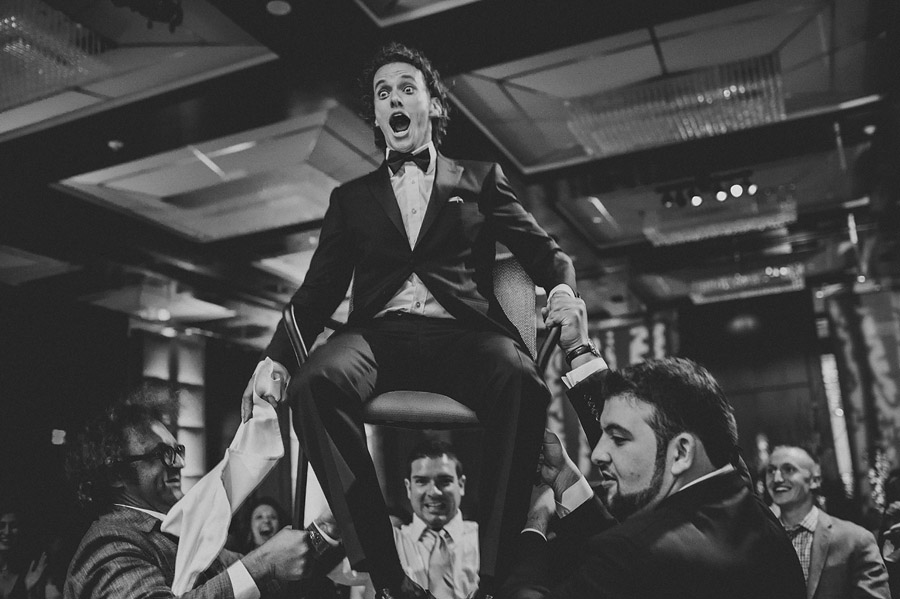 black and white groom reception in chair