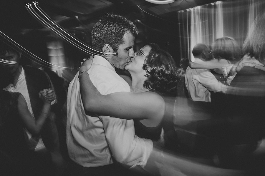 man and woman kissing while dancing at reception