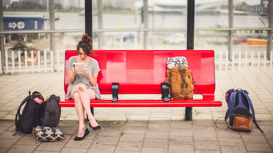 16 person waiting on train station bench person waiting on train station bench