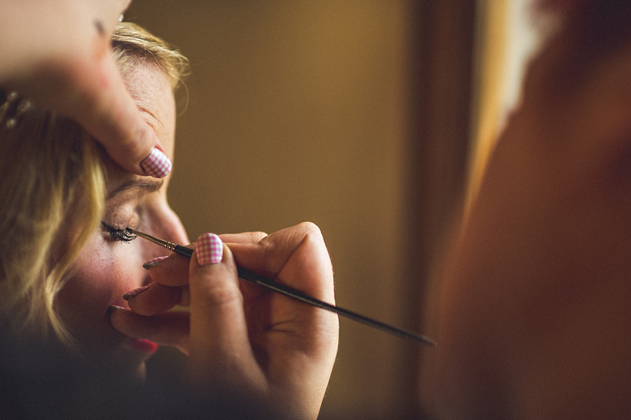 bride getting ready with makeup