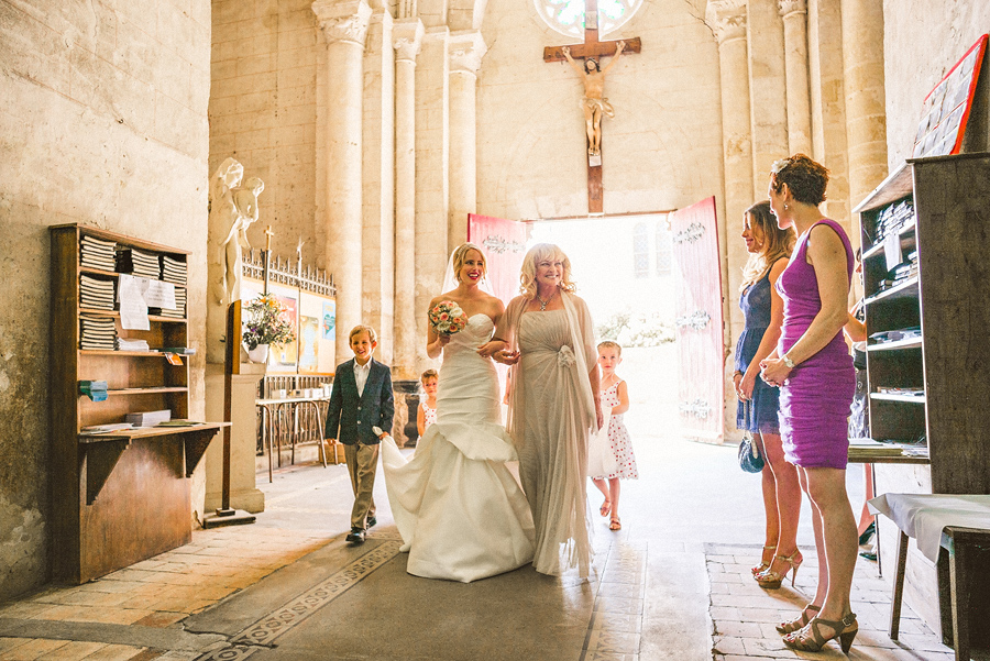 bride walking down aisle with her mother