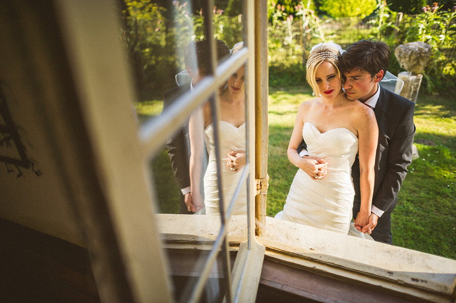 cool window reflection of bride and groom