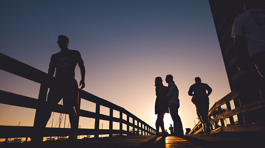 sunset portrait of engaged couple in baltimore harbor