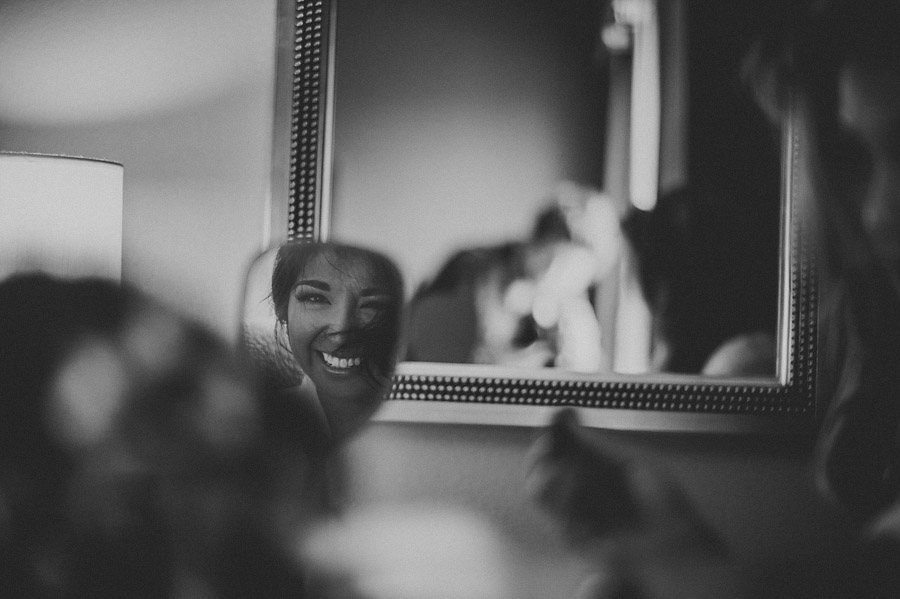 bride getting ready in mirror