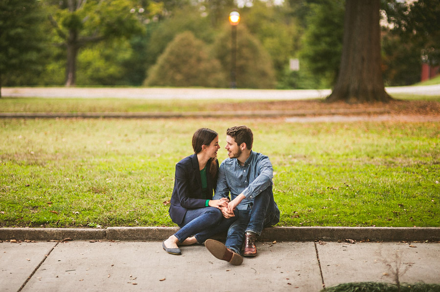 couple sitting on sidewalk