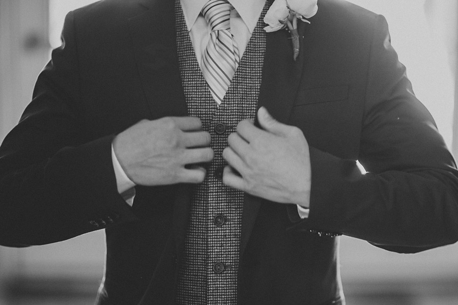 black and white of grooms suit