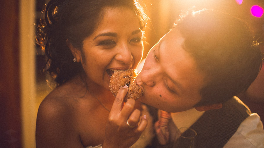 eating a donut at wedding reception