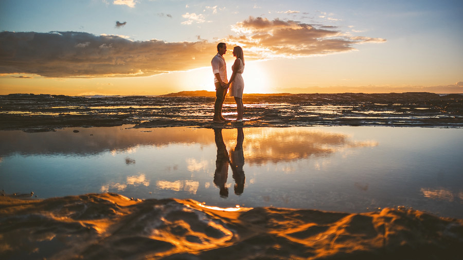 bride and groom at sunrise on australian coast