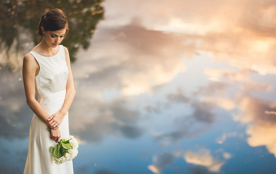 wedding day portrait of bride next to lake
