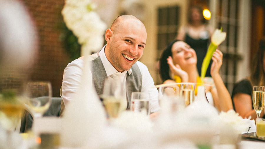 21 groom laughing during toasts groom laughing during toasts