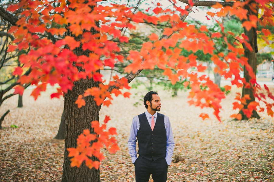 groom portrait in fall leaves