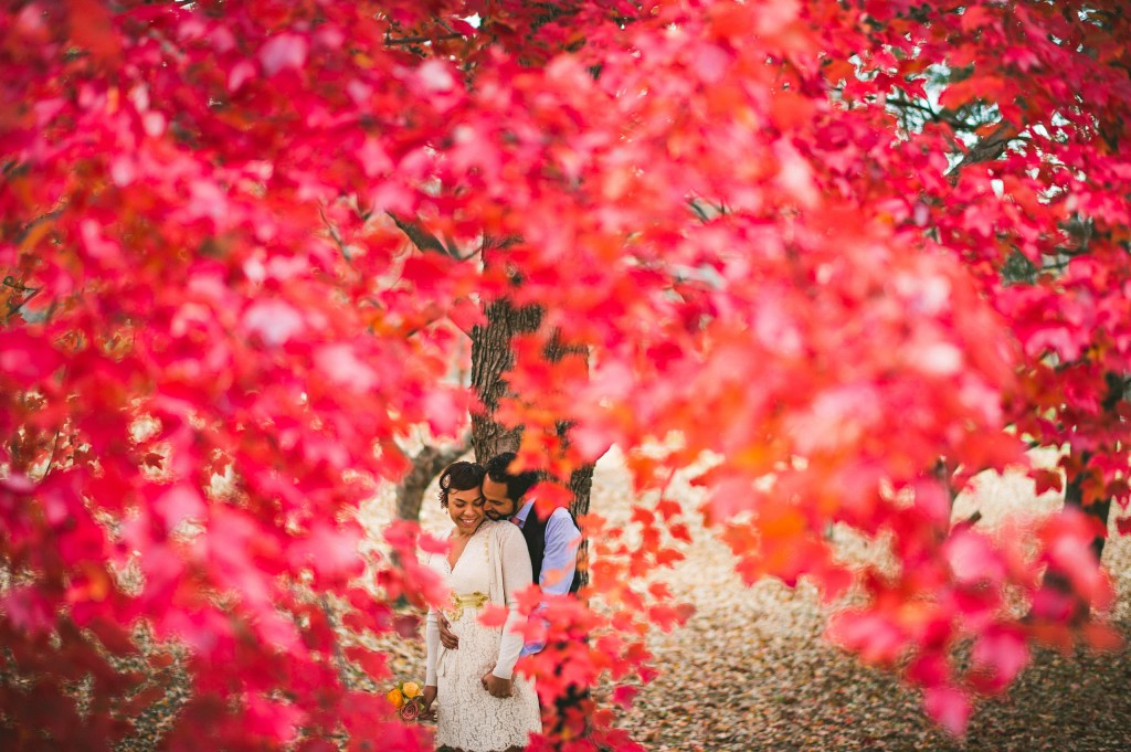 bride and groom through the fall leaves of baltimore