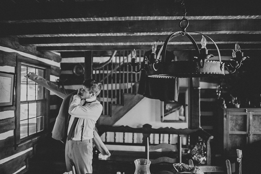 16 groom putting on jacket groom putting on jacket