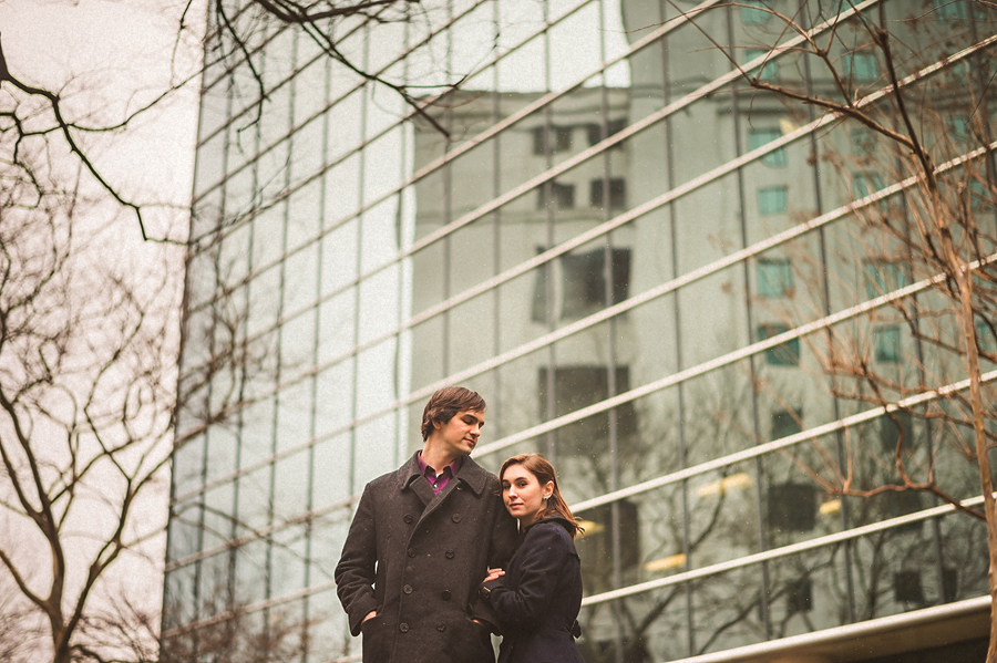 reflective building with trees and a couple for a portrait
