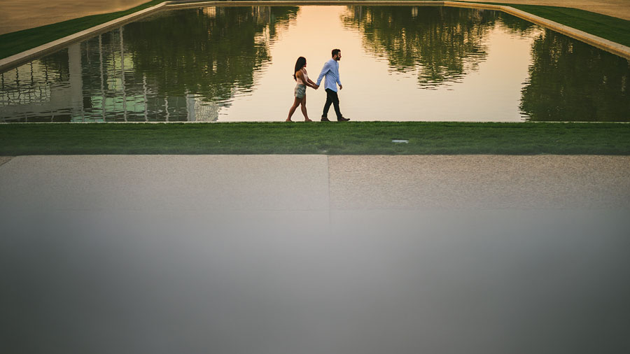 walking along a reflective pool
