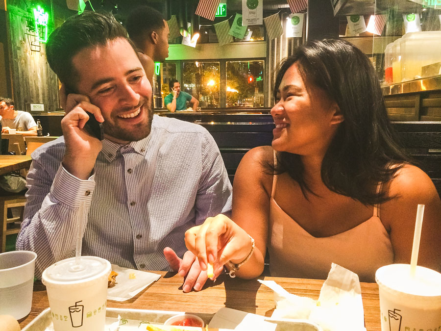 iphone photo of couple calling their mom to announce their engagement