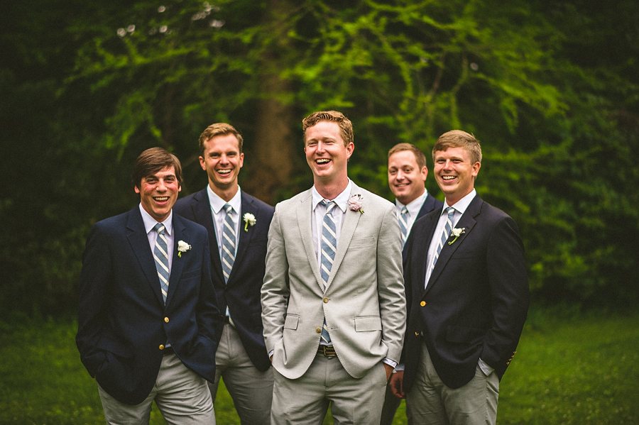 groom with groomsmen laughing outdoors