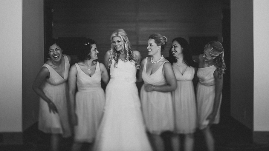 bride with bridesmaids laughing together