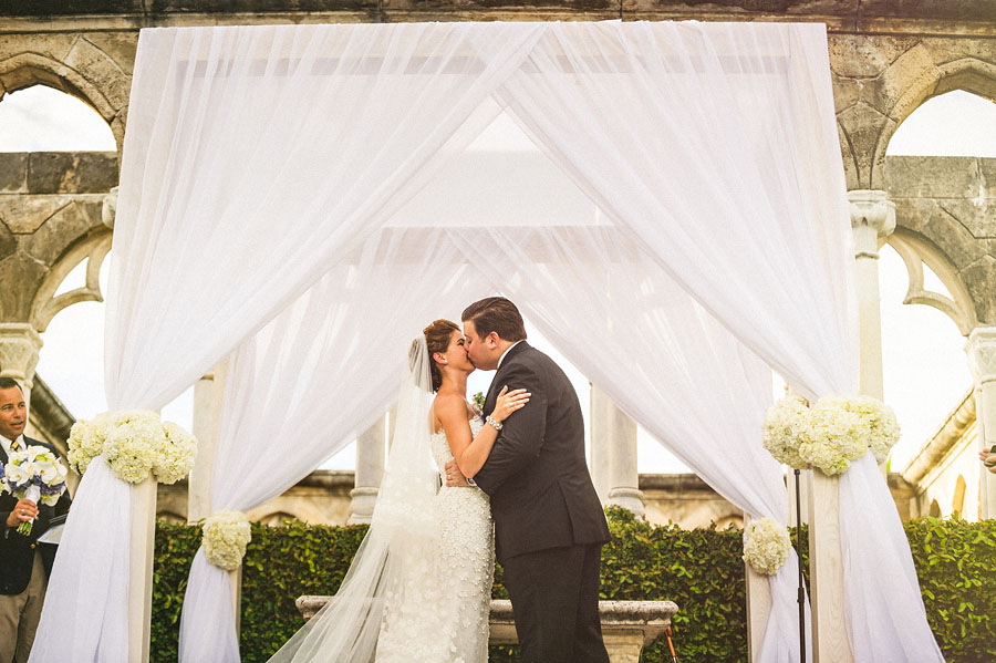 bride and groom first kiss