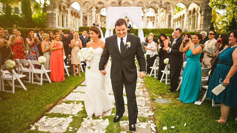 bride and groom walk down aisle