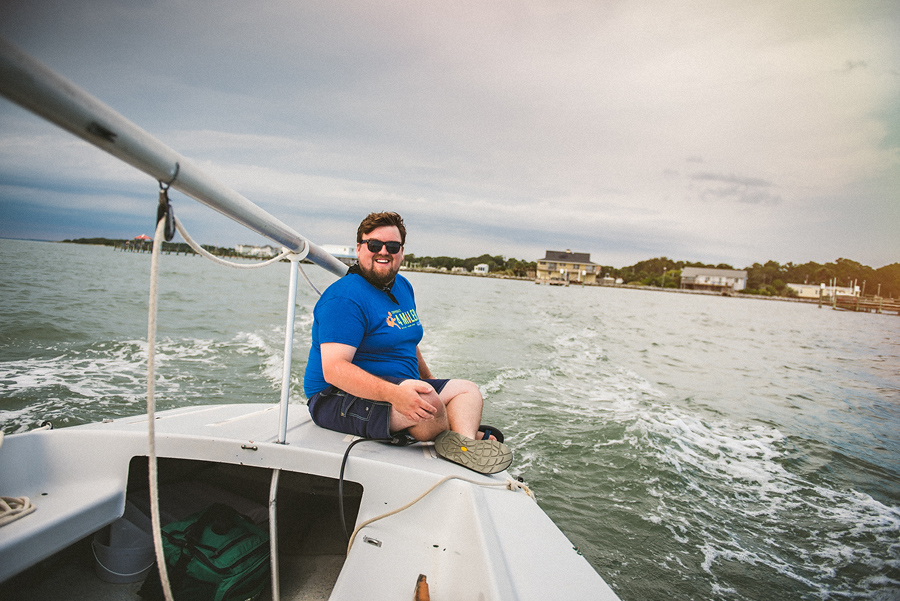 rob sitting on the back of his sailboat