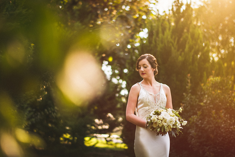 bridal portrait in trees with sun flare