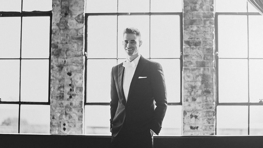 artistic black and white of groom on his wedding day