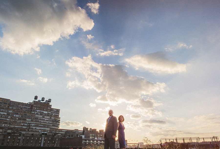 man and woman with awesome cloud at sunset