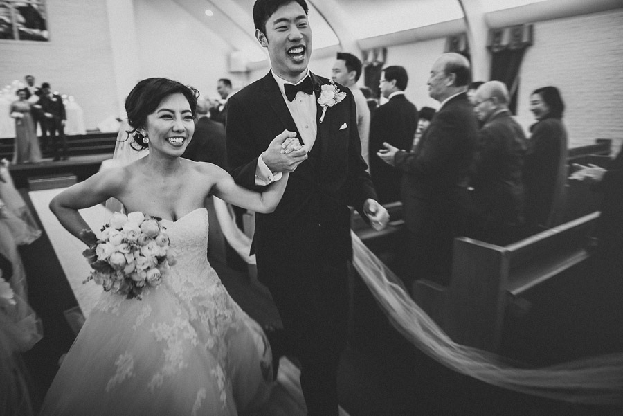 bride and groom running down aisle