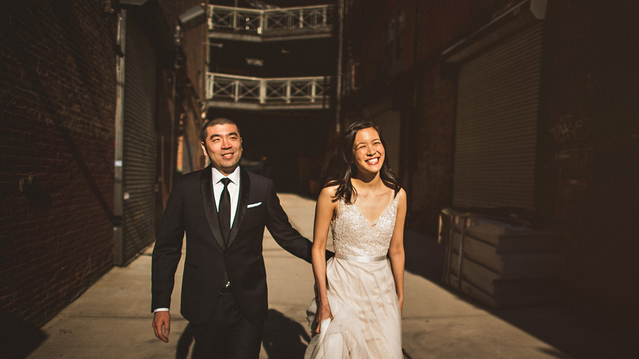 bride and groom laughing and walking together on their wedding day