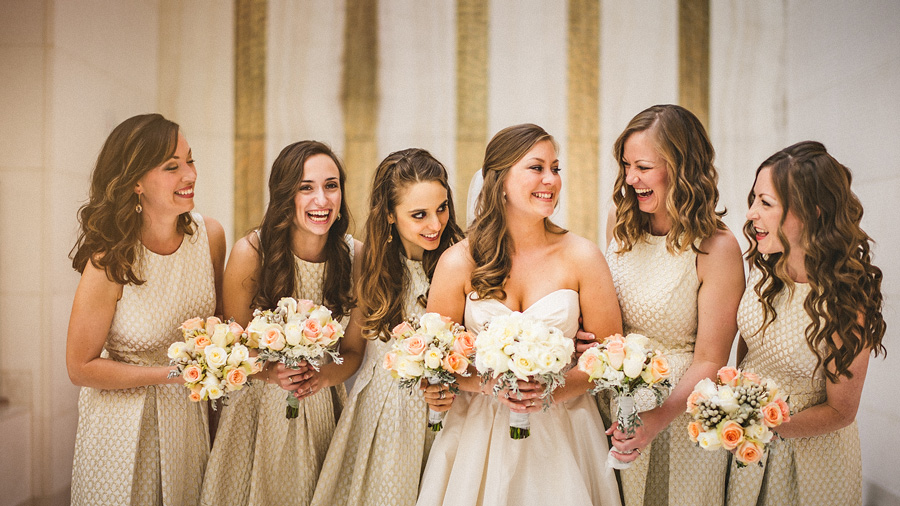 bride and bridesmaids laughing candid