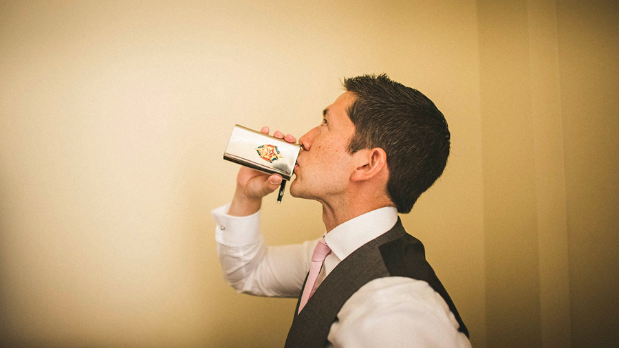groom enjoying a drink bef rewedding ceremony