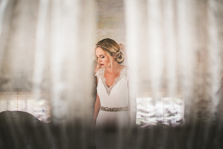 04 bride putting veil on at race and religious wedding