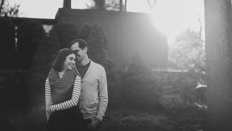 04 black and white photo of couple smiling with sun flare