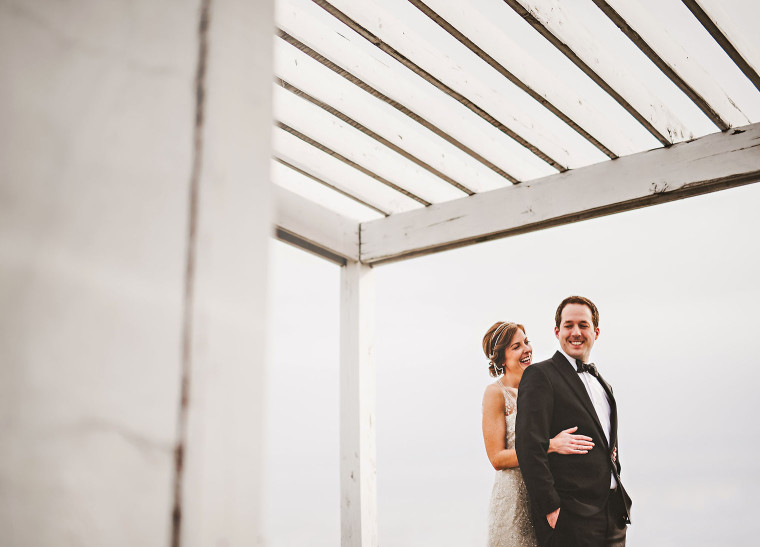 03 bride and groom laughing together on roof