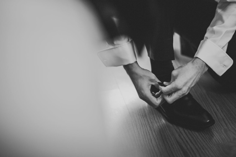 09 groom puting shoe on