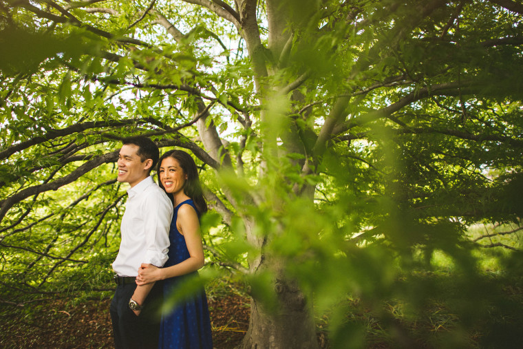 11 couple laughing under tree