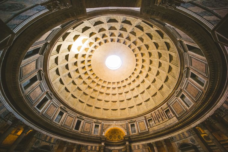 Interior view of the Pantheon's coffered dome with an oculus at the top, letting in natural light.