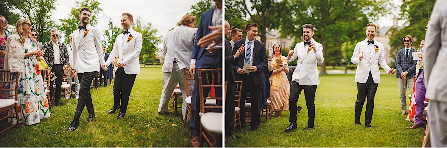 Two grooms in white tuxedos walk down an outdoor aisle, smiling and applauding guests in celebration. The guests, dressed formally, stand and smile under a partly cloudy sky, as if scripted by the perfect auto draft of a beautiful day.
