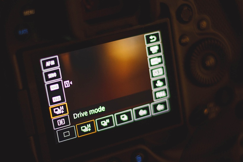 Close-up of a digital camera screen displaying the drive mode settings menu with various icons and options visible, featured in our Canon R3 review.