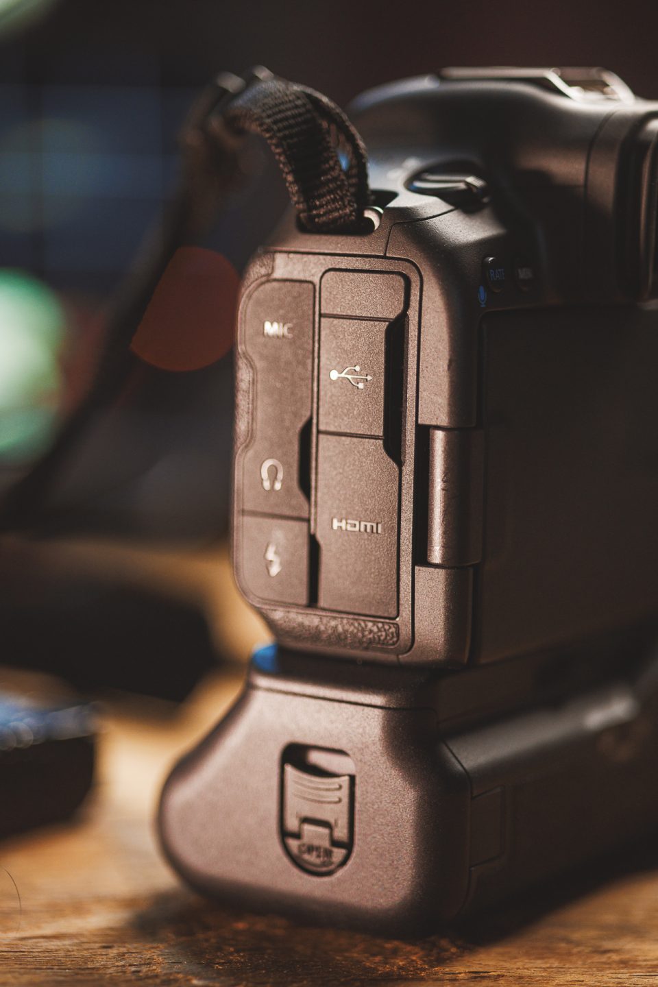 Close-up view of the HDMI, microphone, headphone, and USB ports on the side of a black DSLR camera.