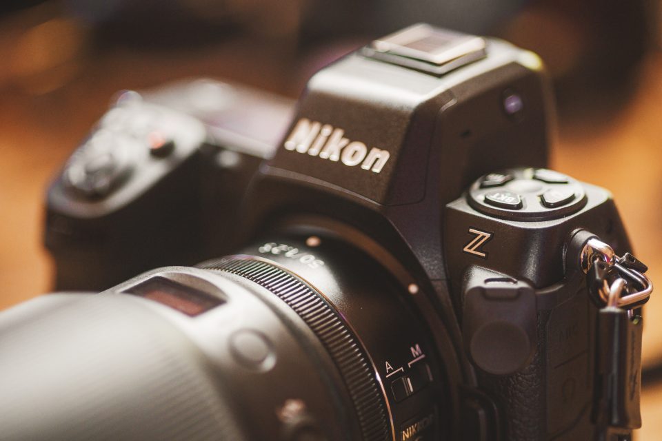 Close-up of a Nikon Z series camera with an emphasis on the lens, controls, and intuitive auto draft features.