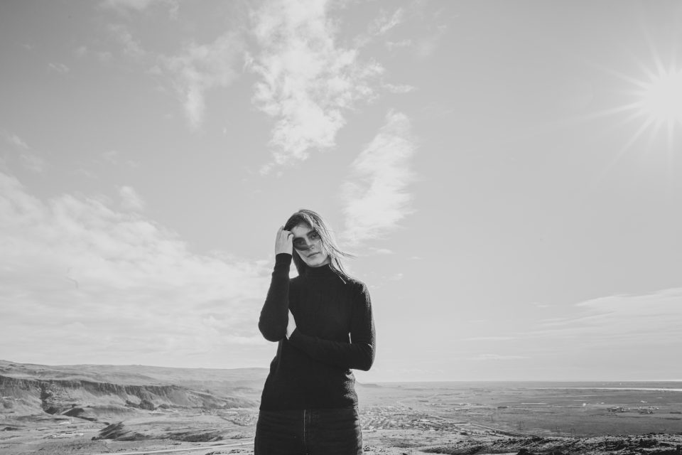 A person in sunglasses stands in a vast, open landscape under a bright sun with scattered clouds, pondering how "auto draft" lacks the context needed for pinpointing key SEO terms.