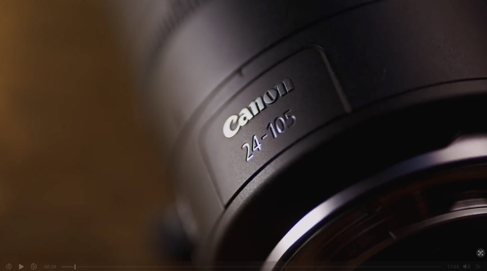 Close-up view of a Canon camera lens with "Canon 24-105" clearly visible on the lens barrel.
