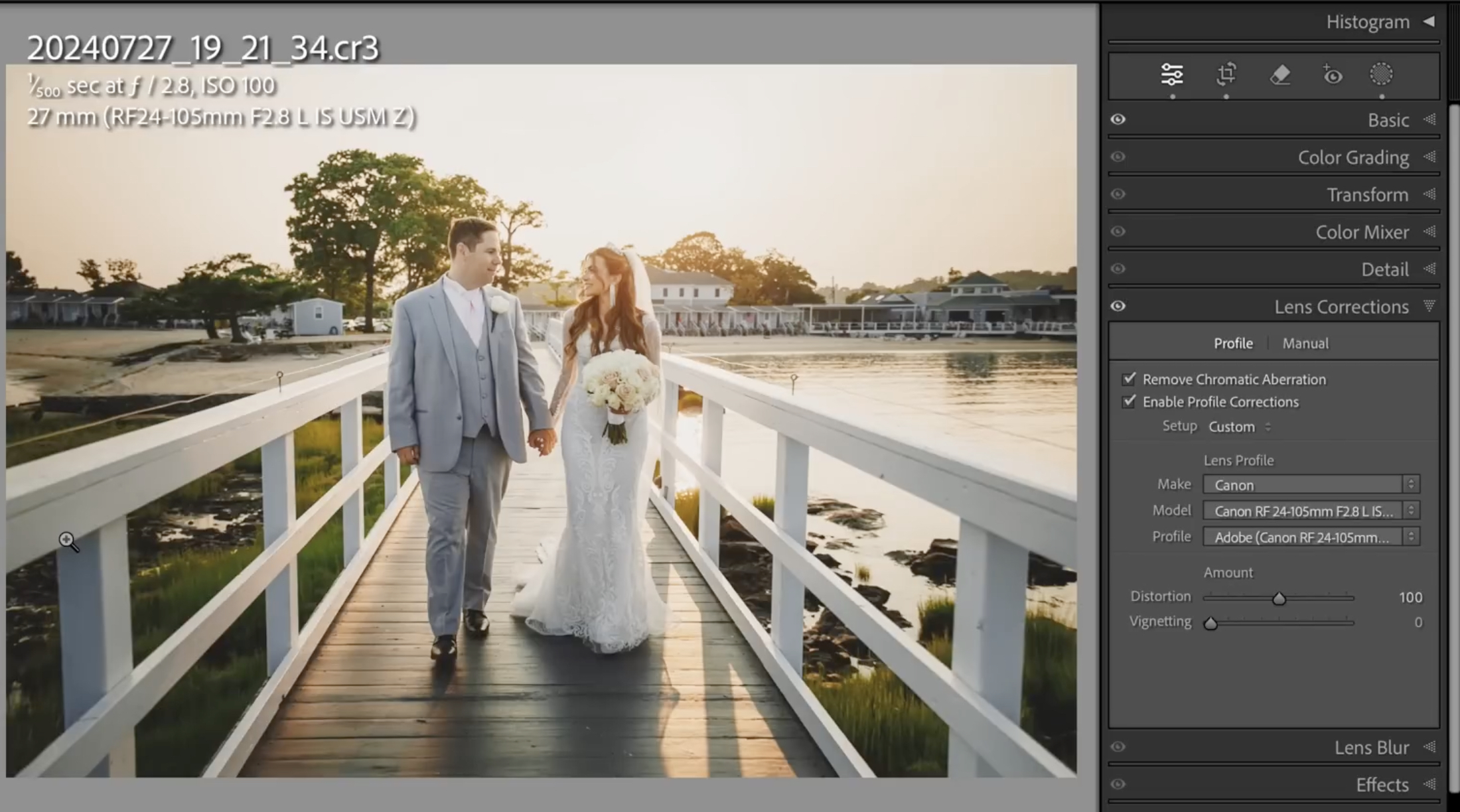 A bride and groom walk hand in hand on a dock at sunset, with water and buildings in the background. Editing controls from photo software are visible on the right side of the image.
