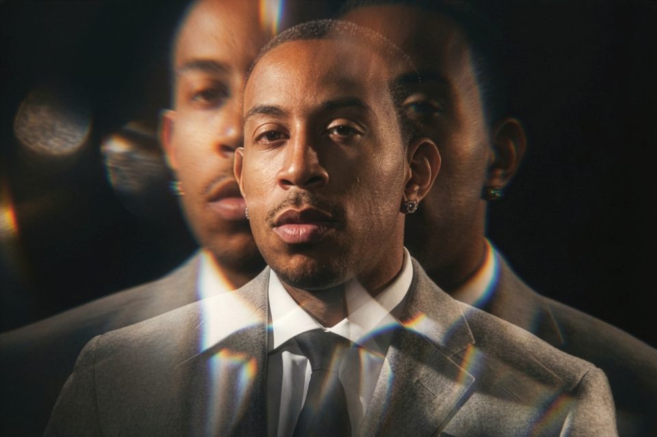 A man in a gray suit and tie is shown with two blurred reflections of his face on either side, creating a prismatic visual effect captured by a skilled DC portrait photographer. A man in a gray suit and tie is shown with two blurred reflections of his face on either side, creating a prismatic visual effect captured by a skilled DC portrait photographer.