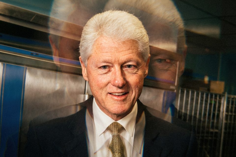 An older man with white hair in a suit and tie stands indoors, captured by a DC portrait photographer using a double exposure effect that creates two faint ghostly images behind him. An older man with white hair in a suit and tie stands indoors, captured by a DC portrait photographer using a double exposure effect that creates two faint ghostly images behind him.
