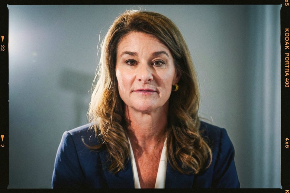 A woman with wavy brown hair, in a navy blazer and white blouse, looks directly at the camera against a neutral background. Captured by a DC portrait photographer, the film border adds a classic touch to the image. A woman with wavy brown hair, in a navy blazer and white blouse, looks directly at the camera against a neutral background. Captured by a DC portrait photographer, the film border adds a classic touch to the image.